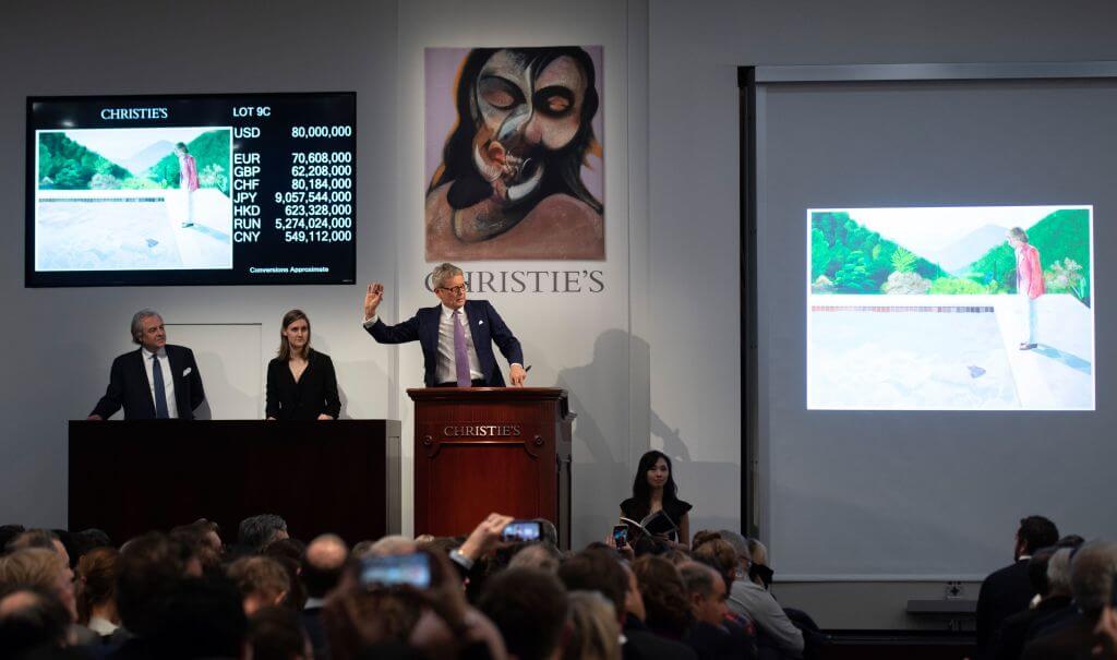 The auctioneer takes bids for the sale of David Hockney's Portrait of an Artist (Pool with Two Figures) during the Post-War and Contemporary Art Evening Sale November 15, 2018 at Christie's in New York. - David Hockneys Famed Pool Scene Sells for $90.3 M. at Christies, New Record for Work by Living Artist at Auction. (Photo by Don EMMERT / AFP) (Photo credit should read DON EMMERT/AFP/Getty Images)